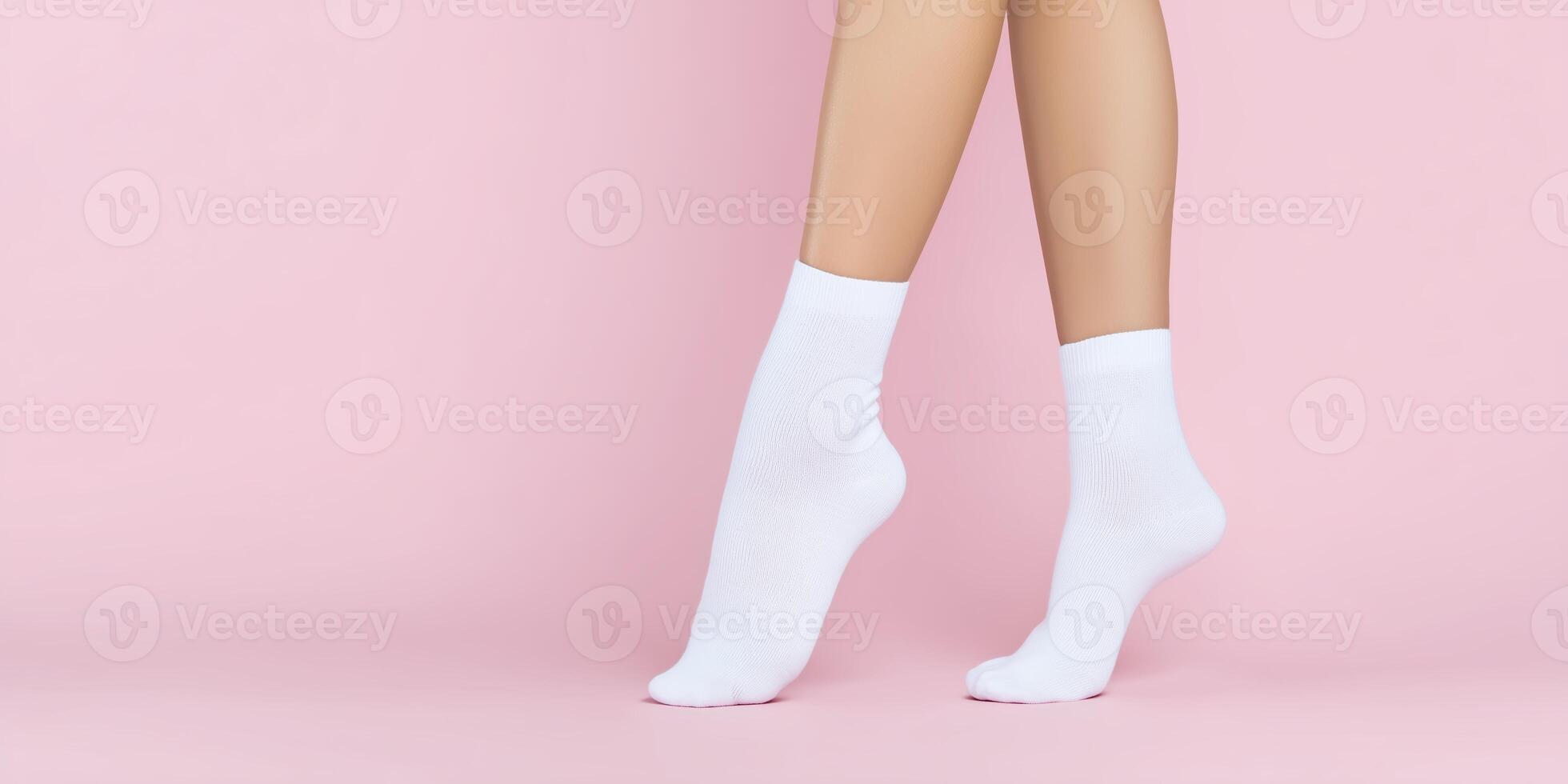 Female legs wearing white socks standing on a soft pink background showcasing comfort and style in a minimalist fashion setting photo