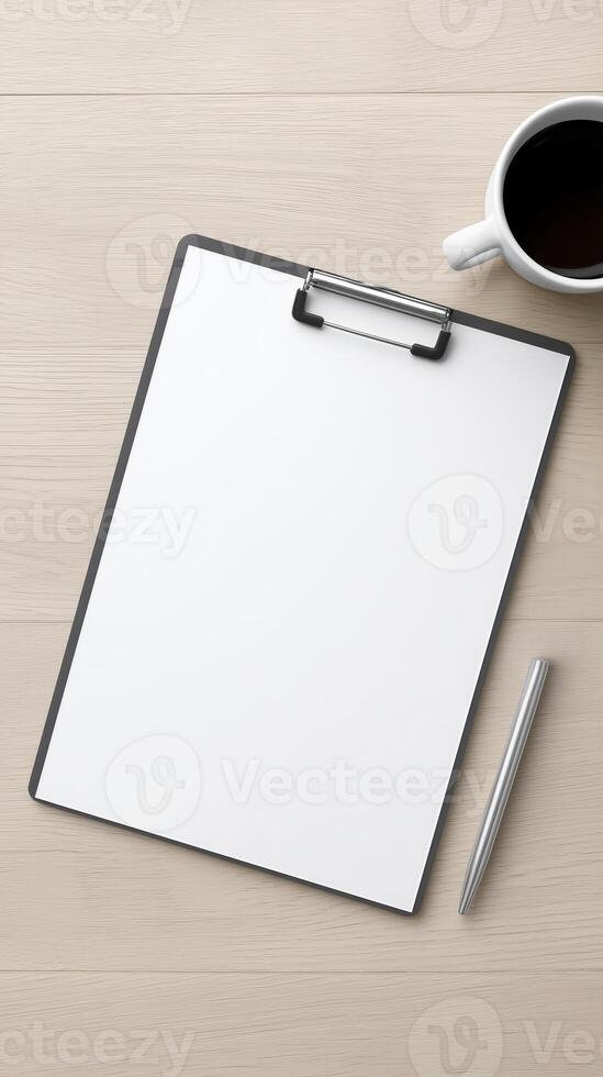 Blank clipboard with white paper, silver pen, and coffee cup on wooden table, ideal for notes, sketches, or creative ideas with copy space photo