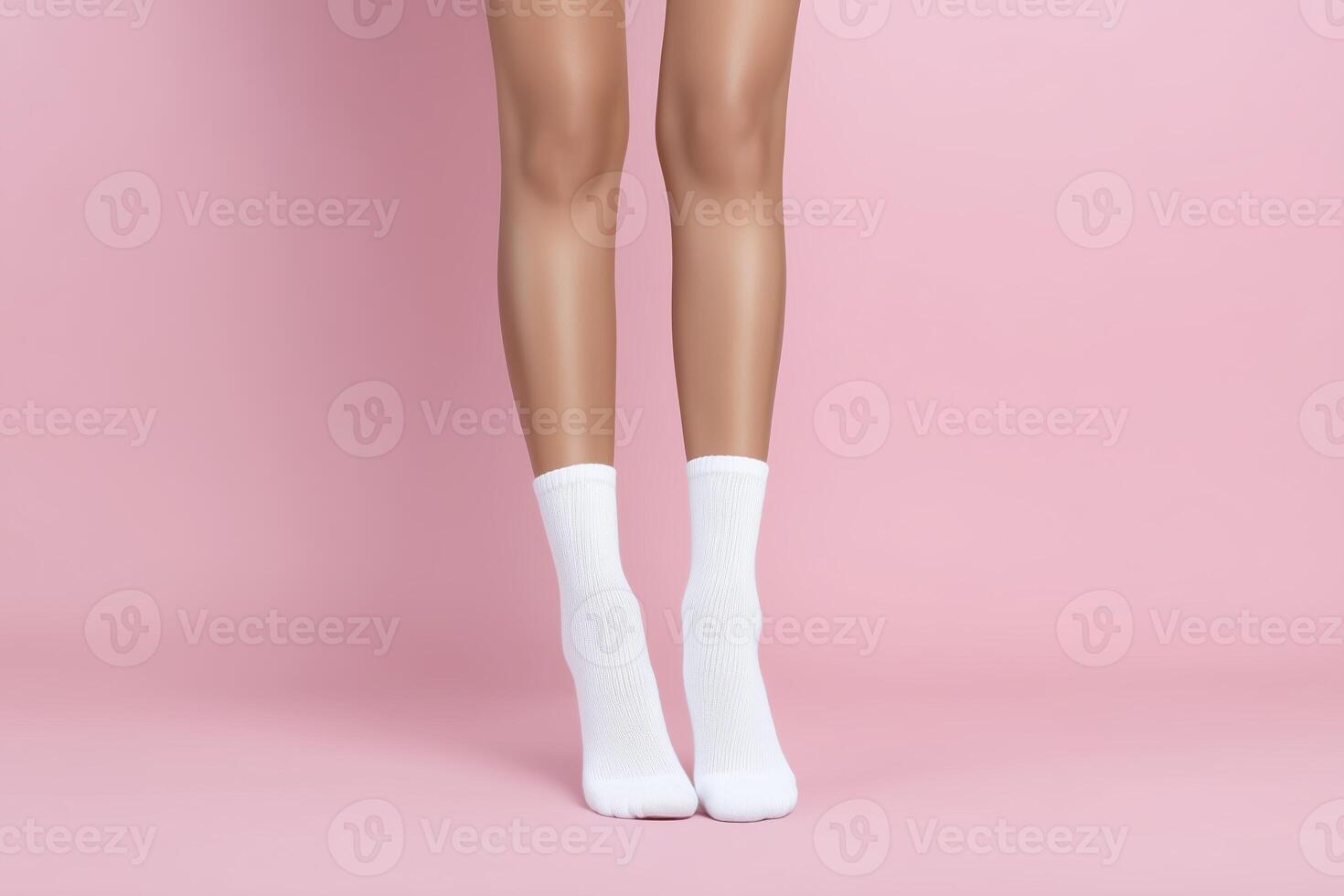 A woman's legs in white socks and a pink background photo