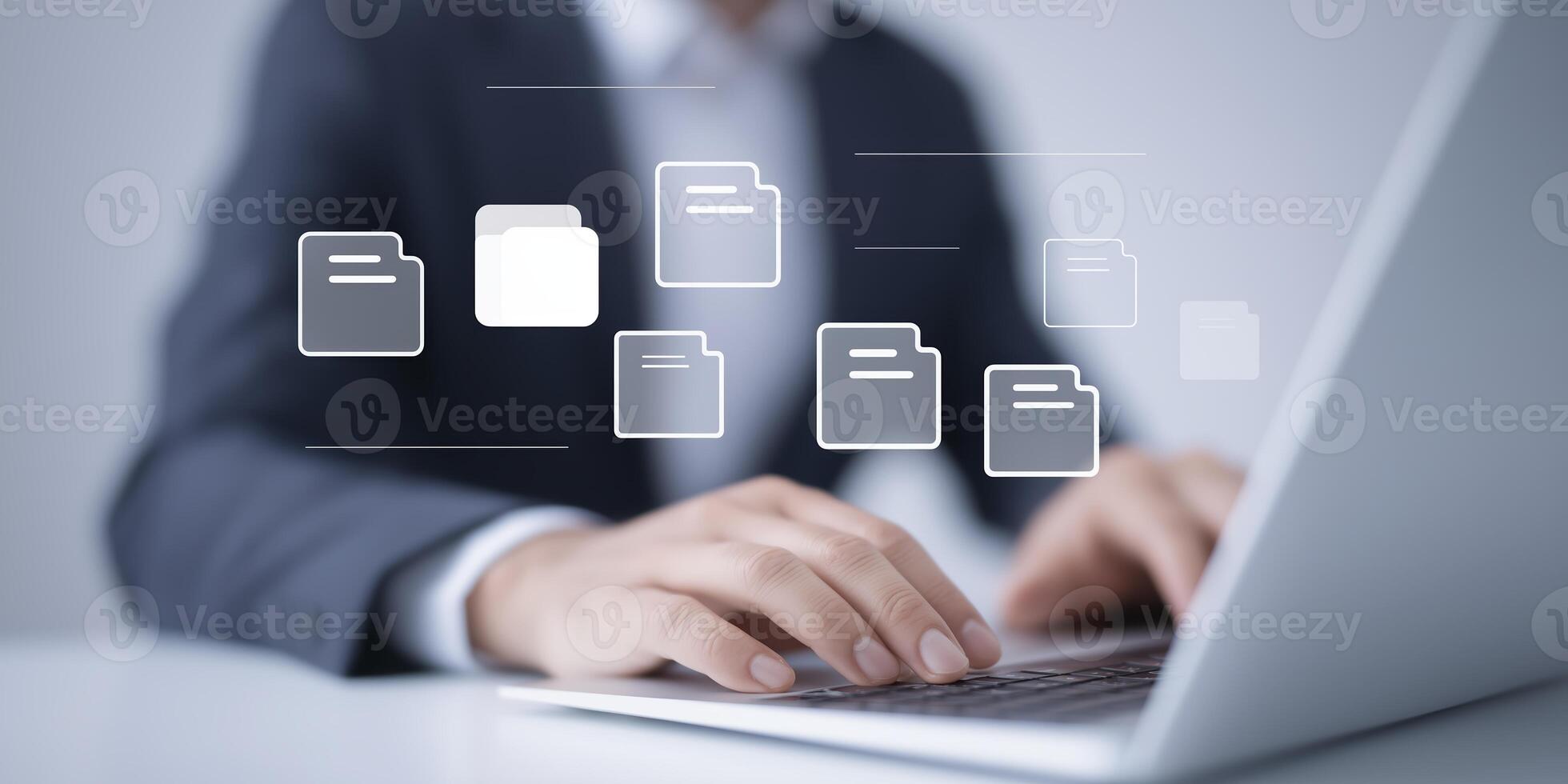 Business professional working on laptop with digital file icons floating above in modern office environment showcasing technology and productivity concepts photo