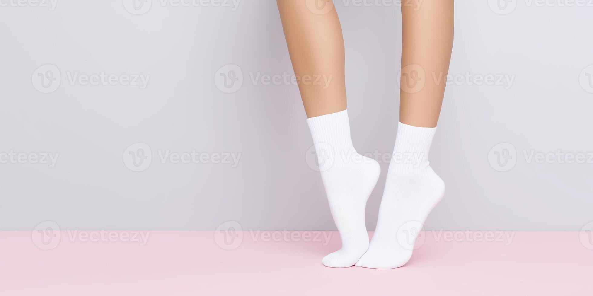 Female legs wearing white socks stand on a soft pink surface, showcasing a minimalist aesthetic with a focus on comfort and casual style in a serene environment photo