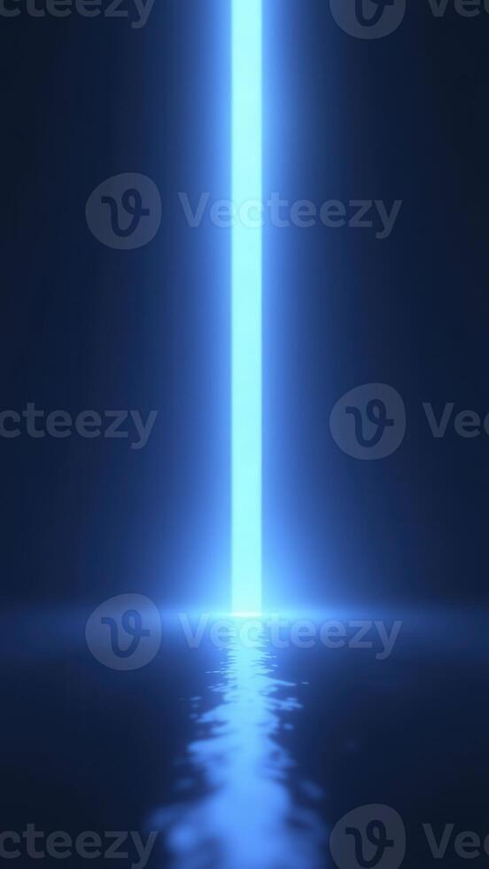 Bright blue light beam shining on water surface in dark room photo