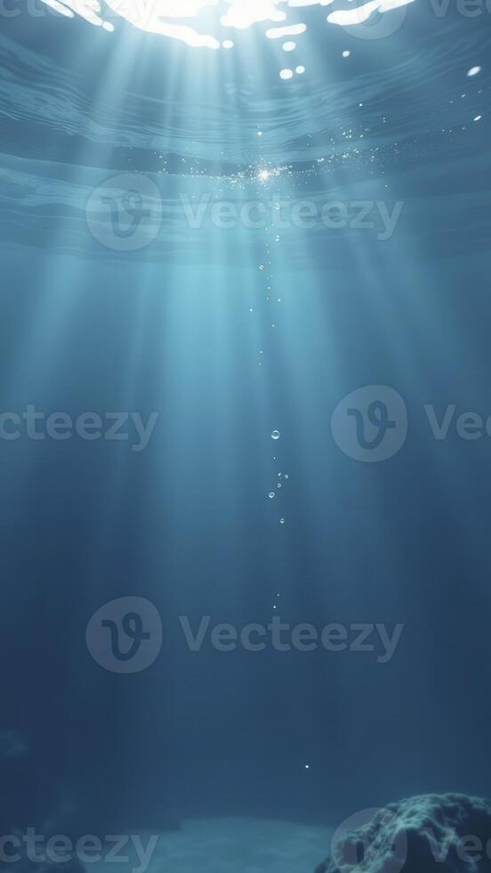 Sunbeams penetrating ocean surface, illuminating underwater scene with air bubbles rising photo