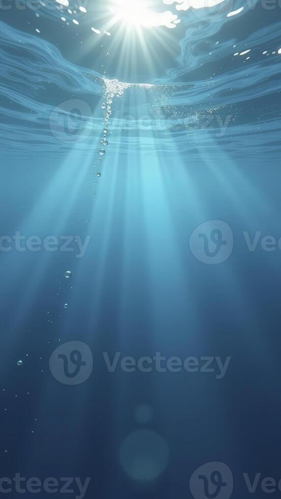 Underwater sunbeams illuminating bubbles rising to the surface photo