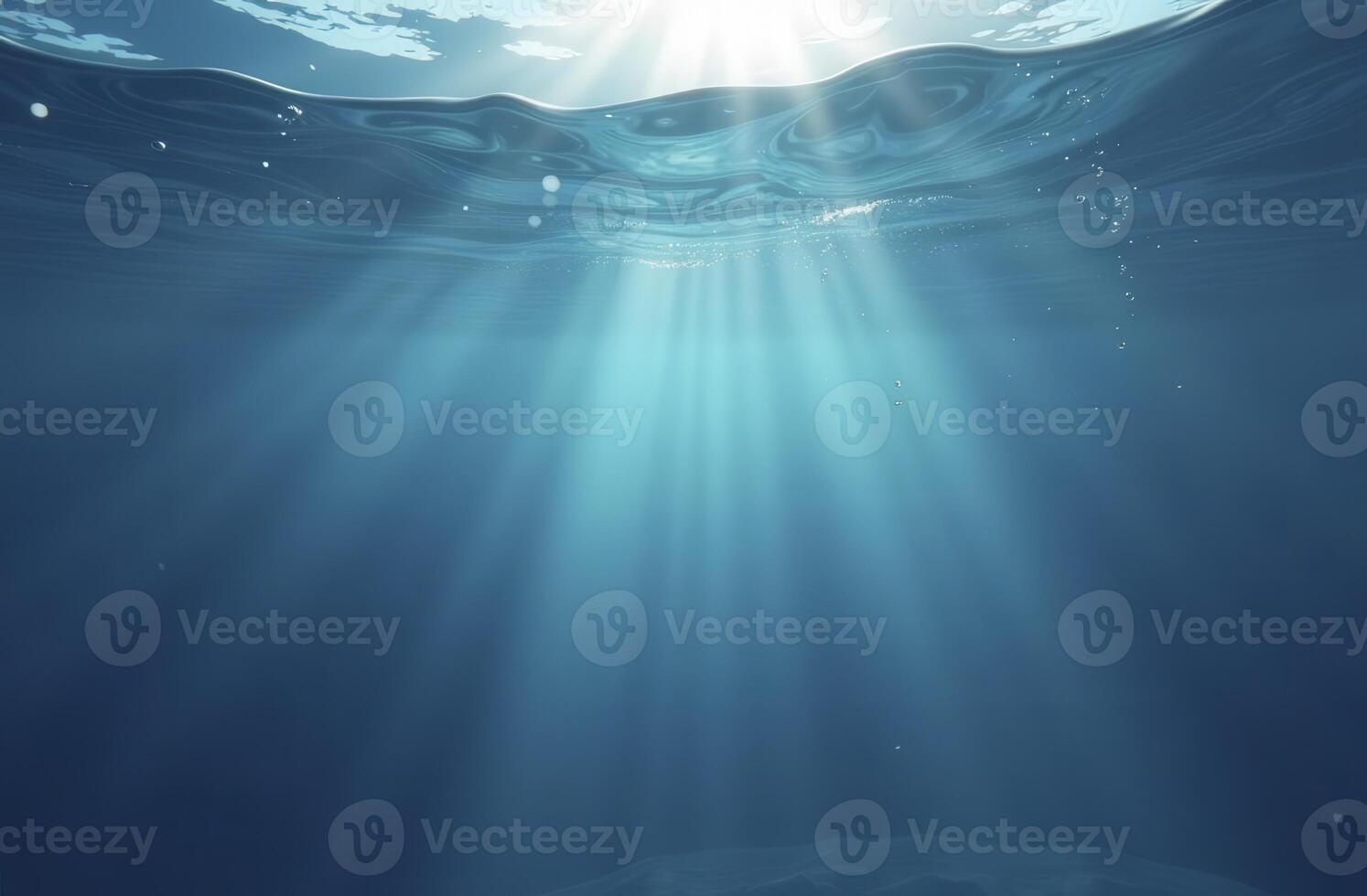 Sunlight piercing through ocean surface creating beautiful underwater beams photo