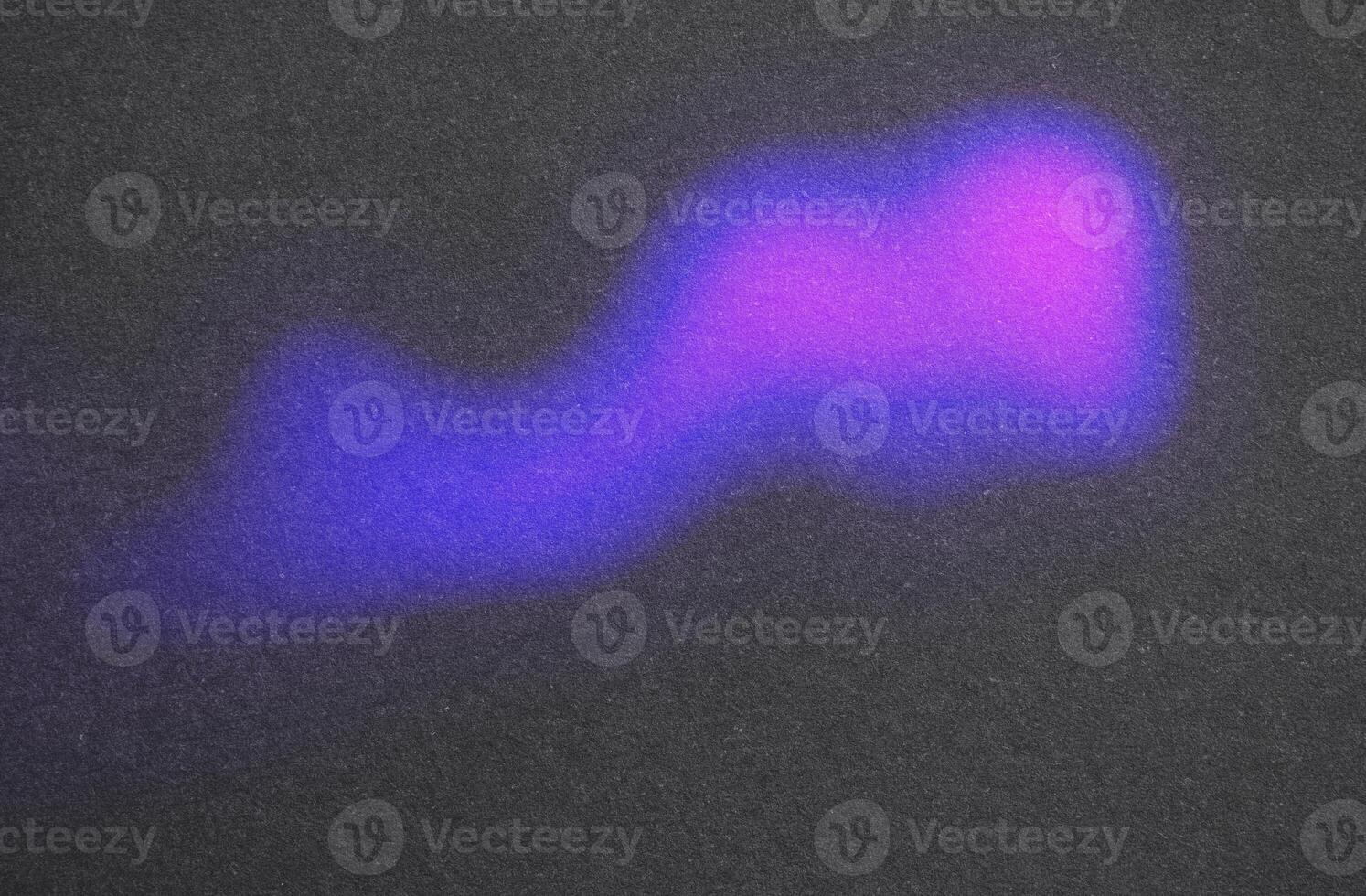 Glowing purple and blue light on dark surface photo