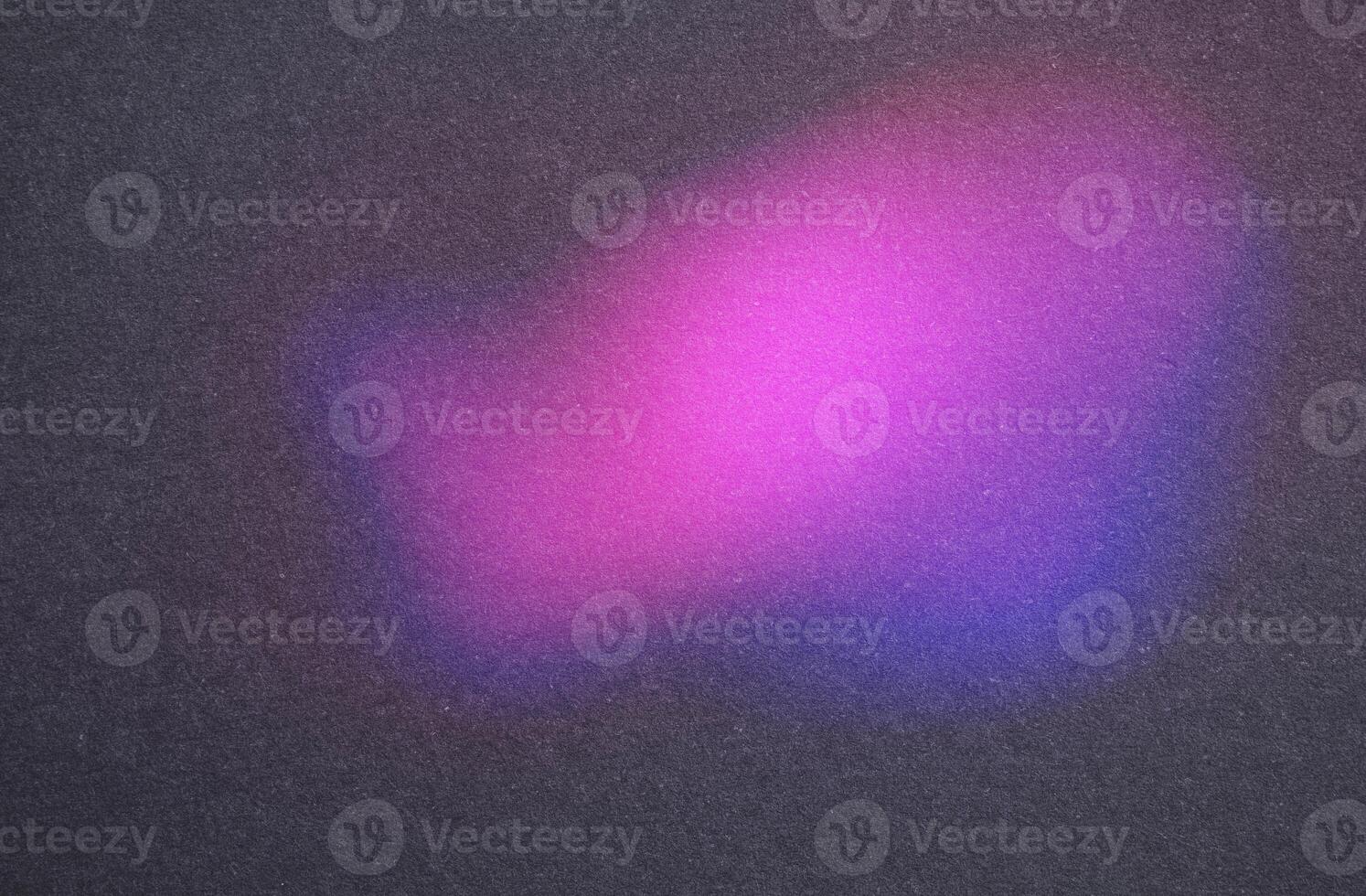 Soft, colorful glow in a dark, textured setting photo