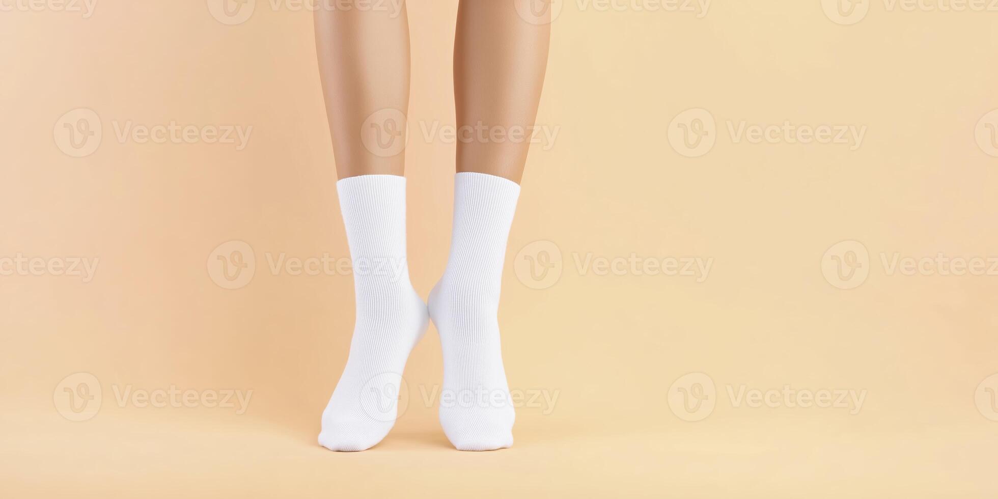 Close-up view of bare legs wearing white socks standing on a soft pastel background, showcasing comfort and style in casual fashion and home relaxation photo