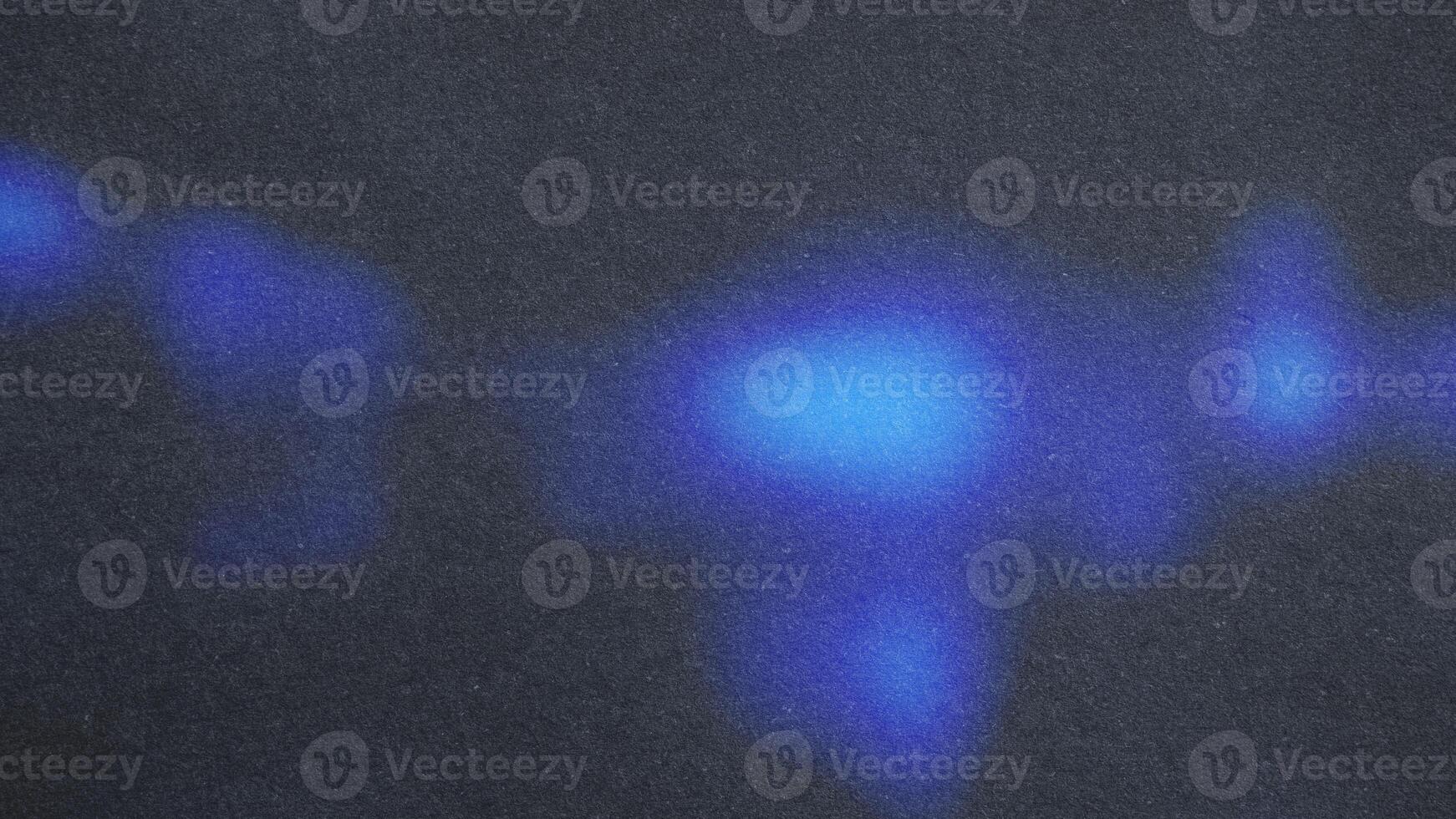 Blue light painting on dark textured background creating abstract shapes photo
