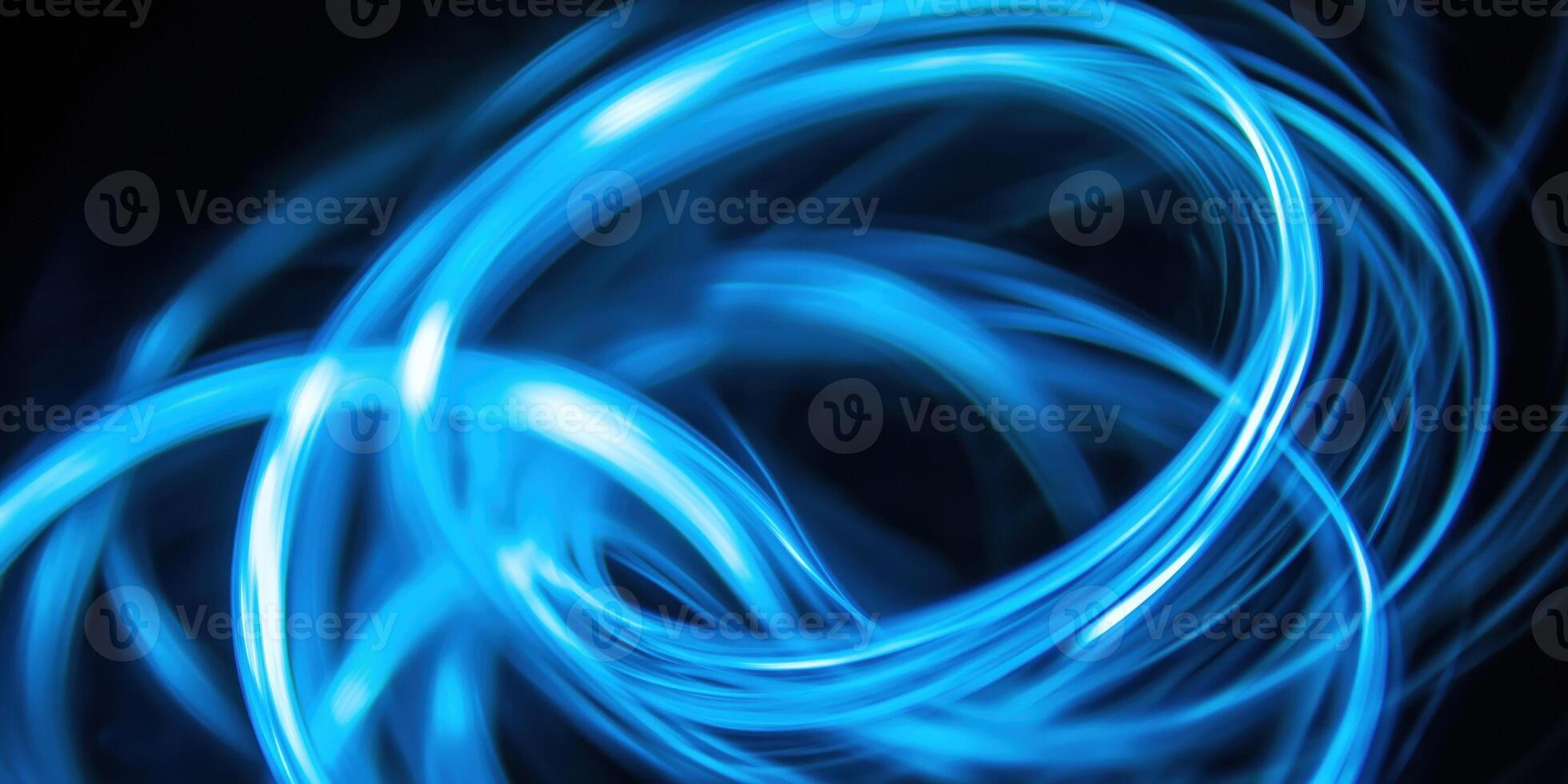 Abstract blue light trails creating swirling pattern on dark background photo