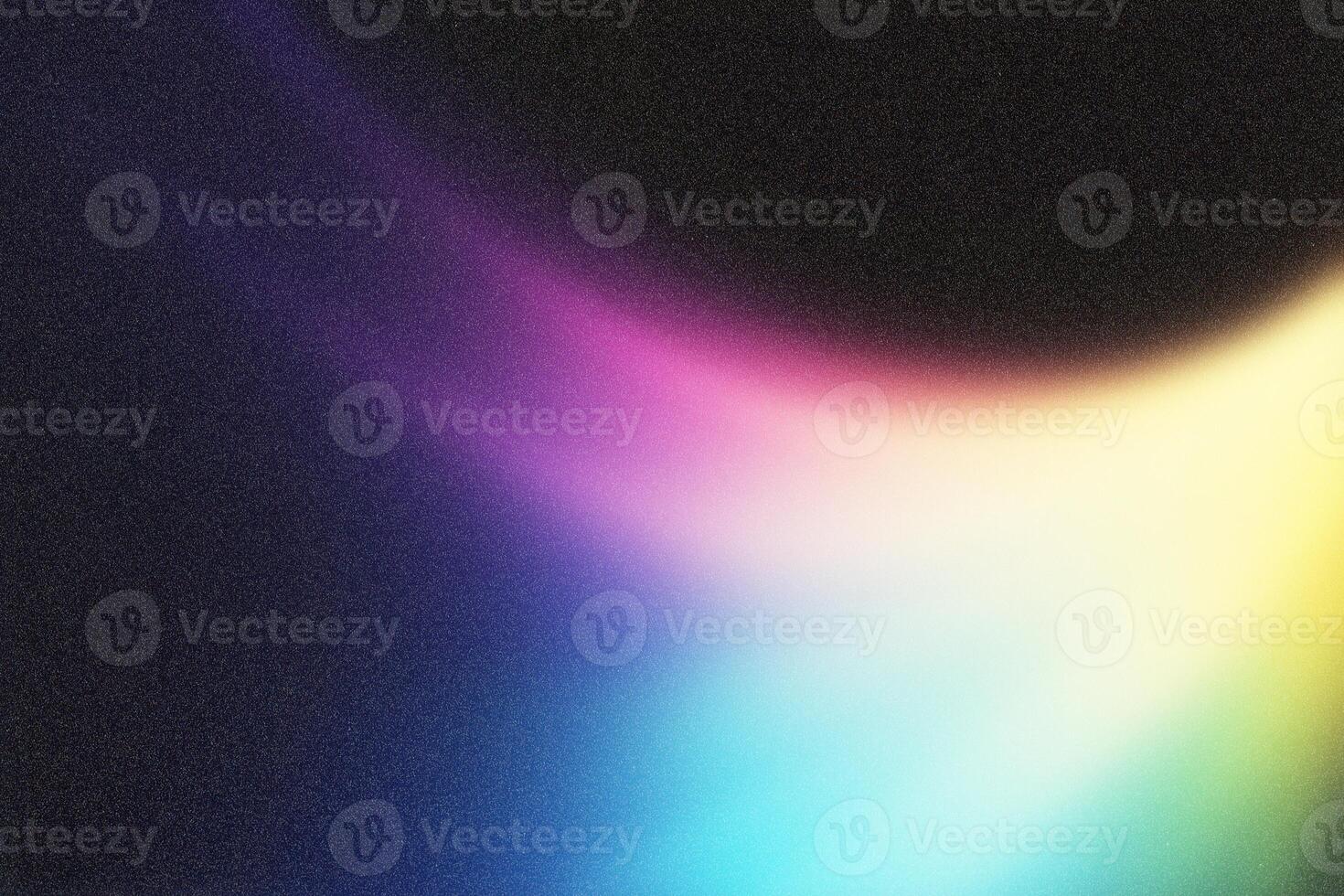 Colorful light leak creating a spectrum on dark background photo