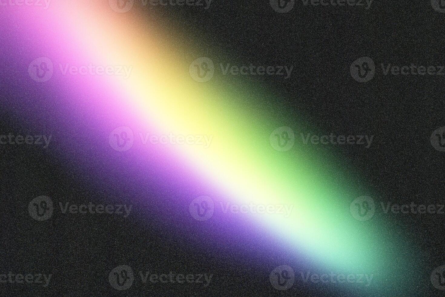 Diagonal rainbow gradient fading on grainy black background photo