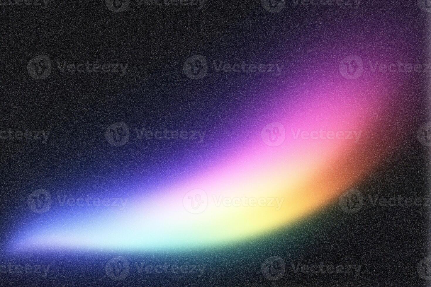 Colorful light streak shining on dark textured background photo