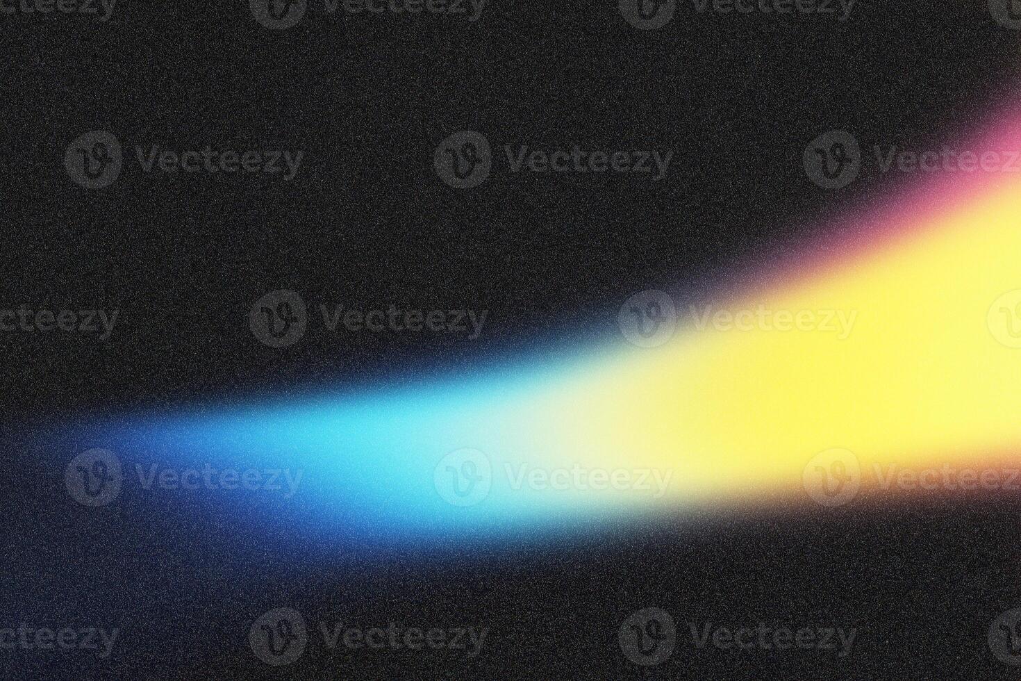 Light beam illuminating black grainy background with blue and yellow gradient photo