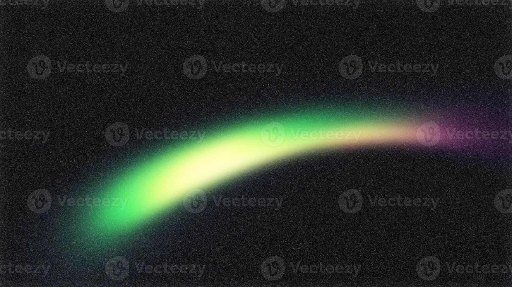 Green and purple light trail painting a curved line on black background photo