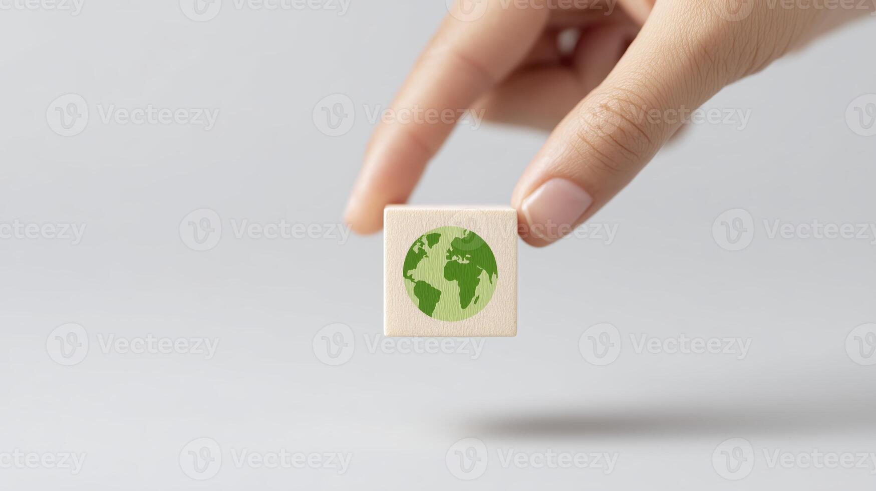 Hand holding a green earth globe on a white background photo