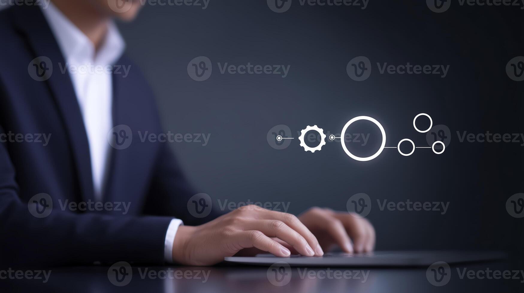 Business professional in dark suit interacts with digital interface, showcasing gears and circles, symbolizing technology and innovation in a modern workspace environment photo