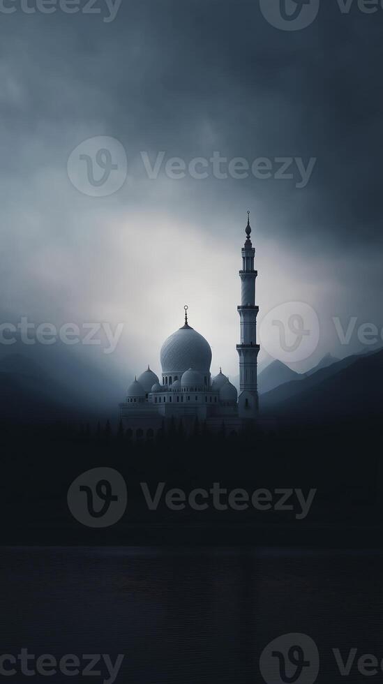 Majestic mosque silhouette against a dramatic cloudy sky, surrounded by mountains and reflecting on calm water, creating a serene and spiritual atmosphere photo