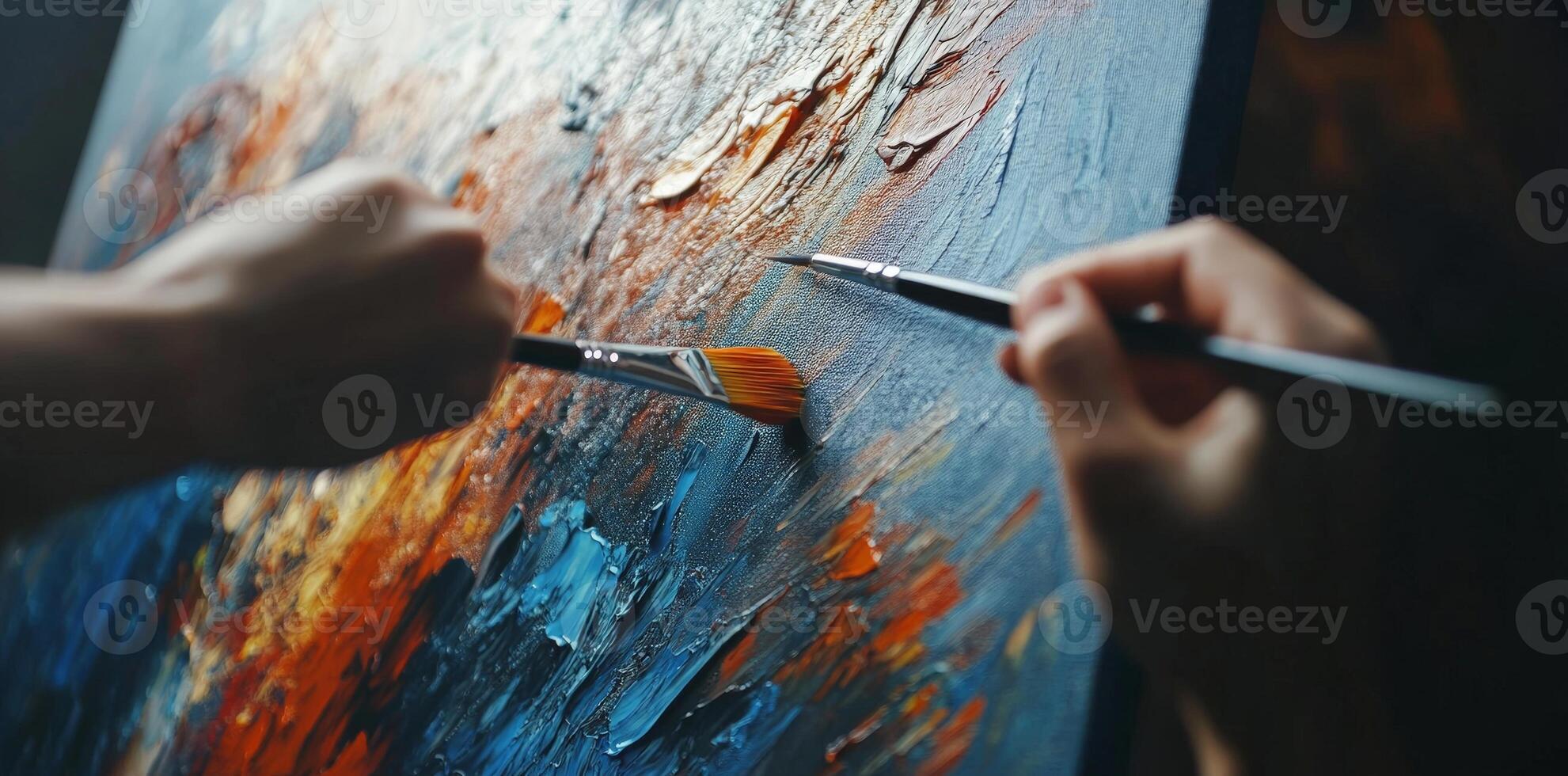 Hands Painting With Paintbrushes On Canvas Creating Abstract Artwork With Blue Orange And White Colors photo