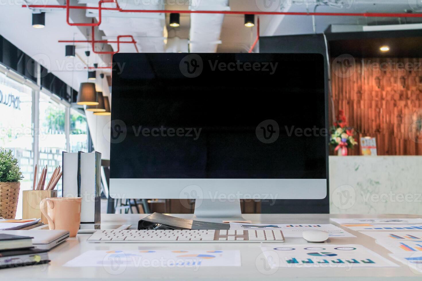 A computer monitor sitting on a desk in front of a desk photo
