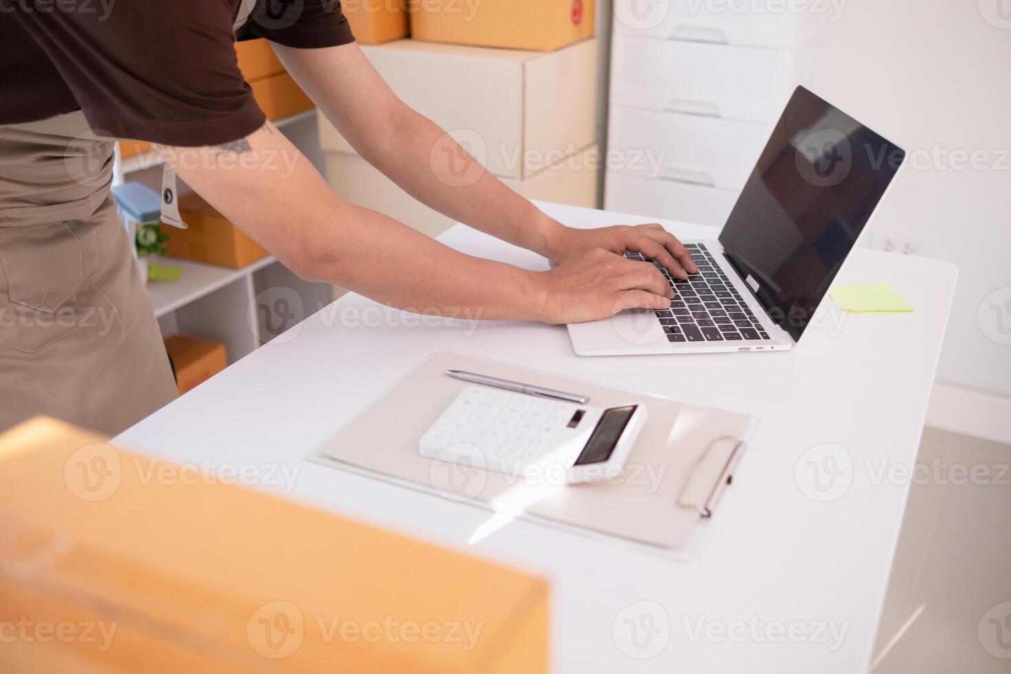A man working on his laptop in an office photo