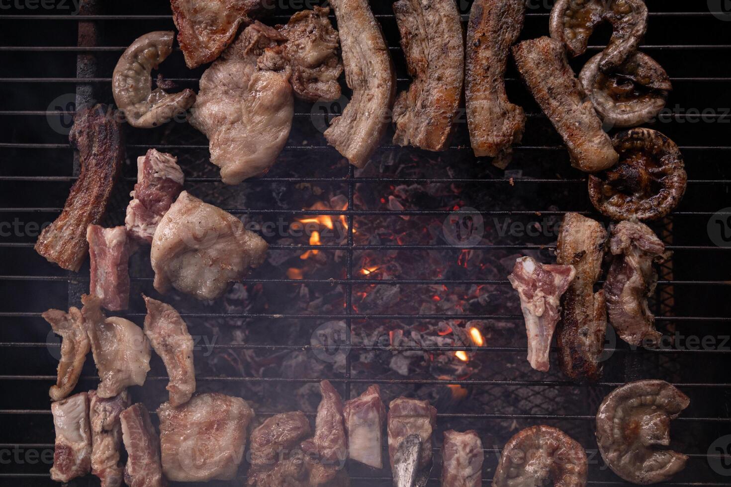 A grill with meat and other items on it photo