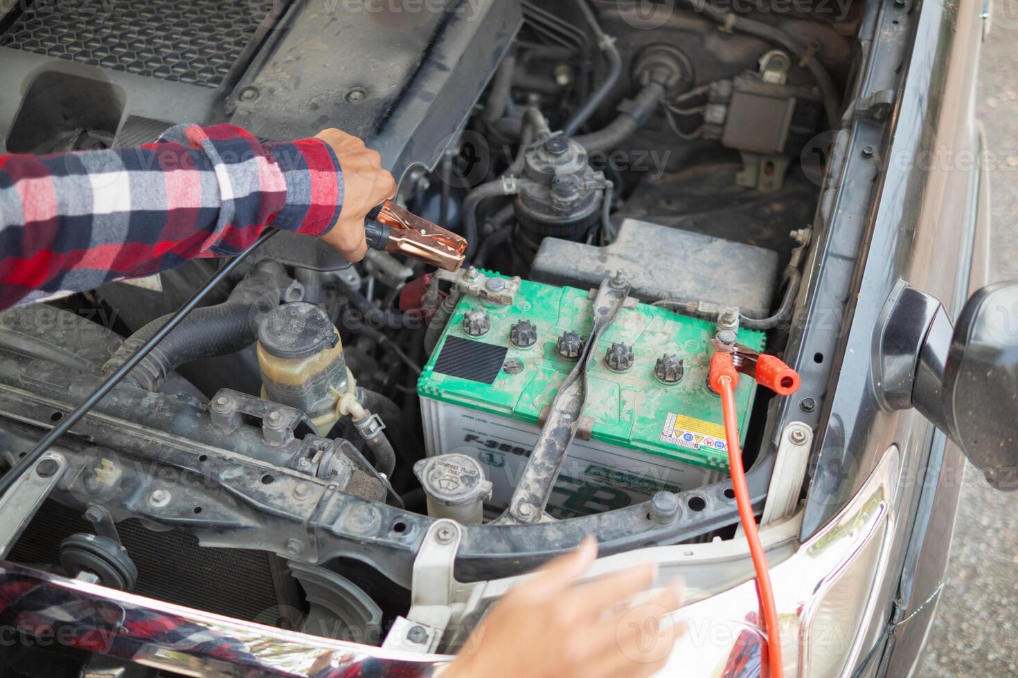 A man is holding a battery in his hand photo