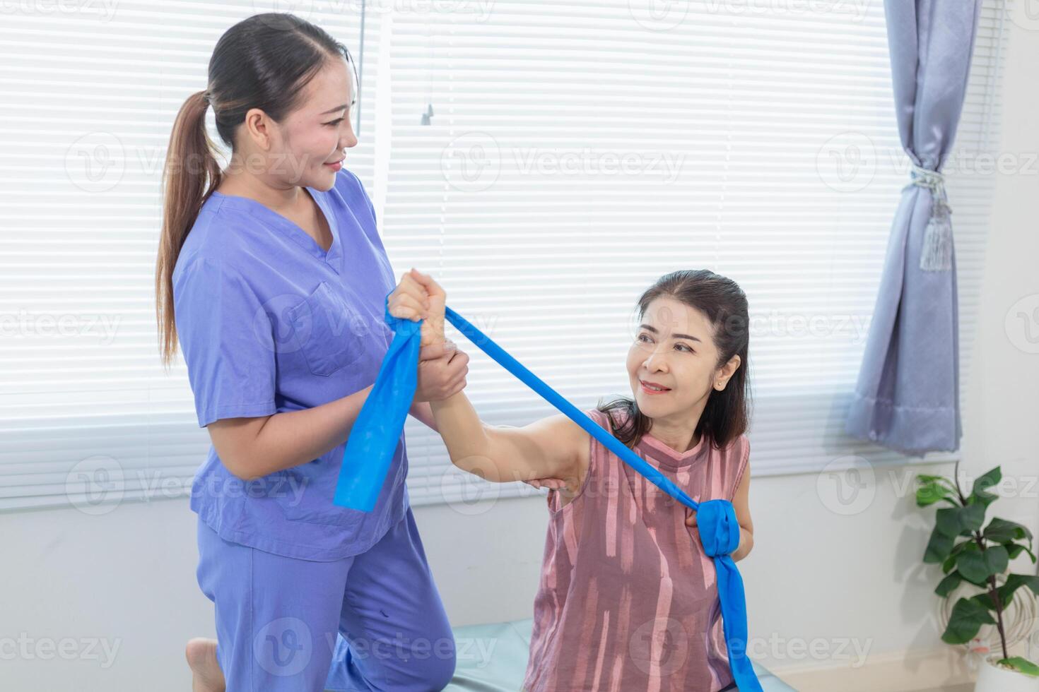 female doctor is taking care of an elderly person and helping elderly person do physical therapy help muscles work and check function of muscle system when elderly person starts recover injury. photo