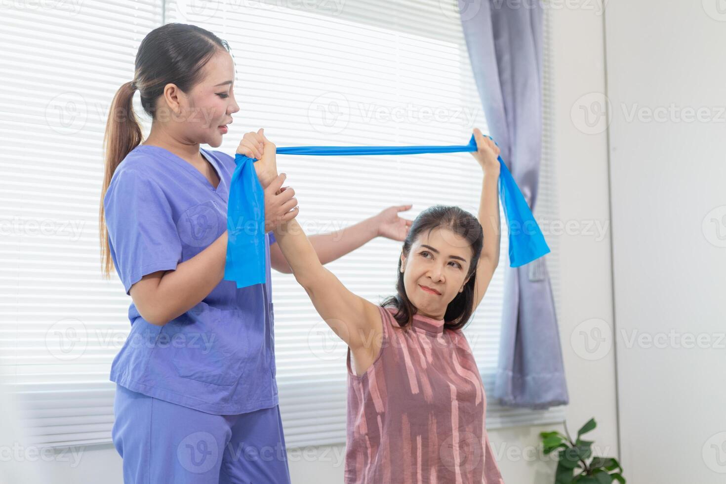 female doctor taking care of an elderly person and helping elderly person do physical therapy help muscles work and check function of muscle system when elderly person starts recover from injury. photo