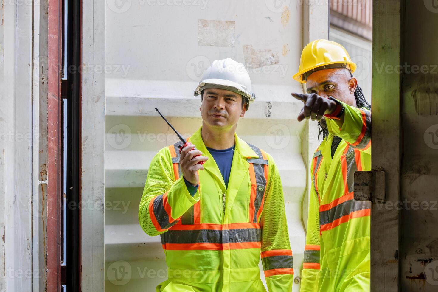 Workers man team inspecting containers box at shipping container cargo, Engineer and foreman working in industry containers yard photo