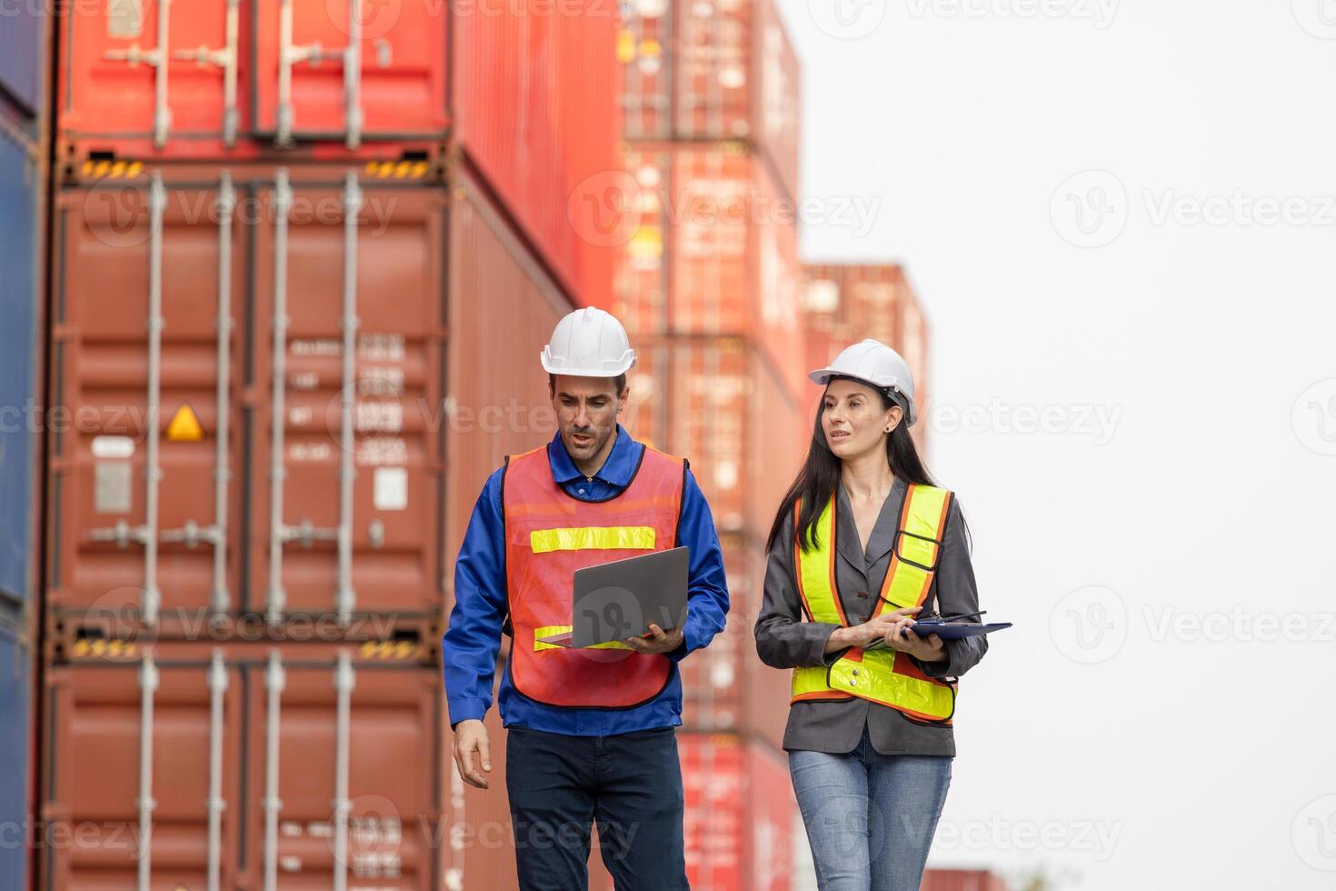 Foreman dock workers checking loading containers box at shipping yard, Logistics workers at shipping port with containers, Industrial engineers managing cargo operations photo