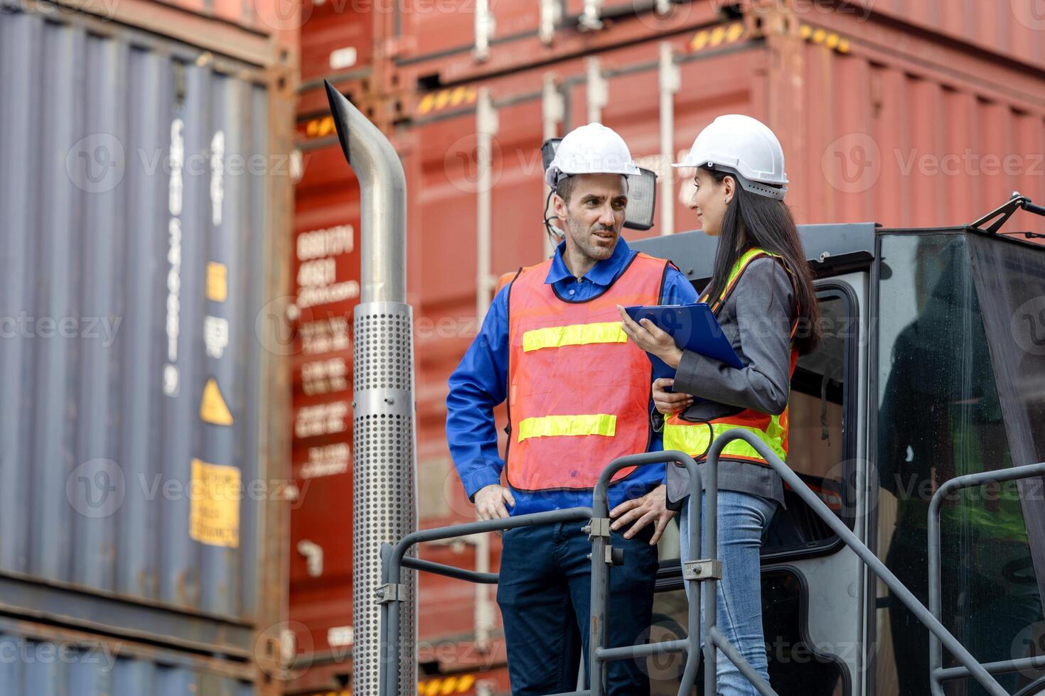 Engineers and Foreman Workers Team on Loaded Container Handler Control Loading Containers Box at at Shipping Yard photo