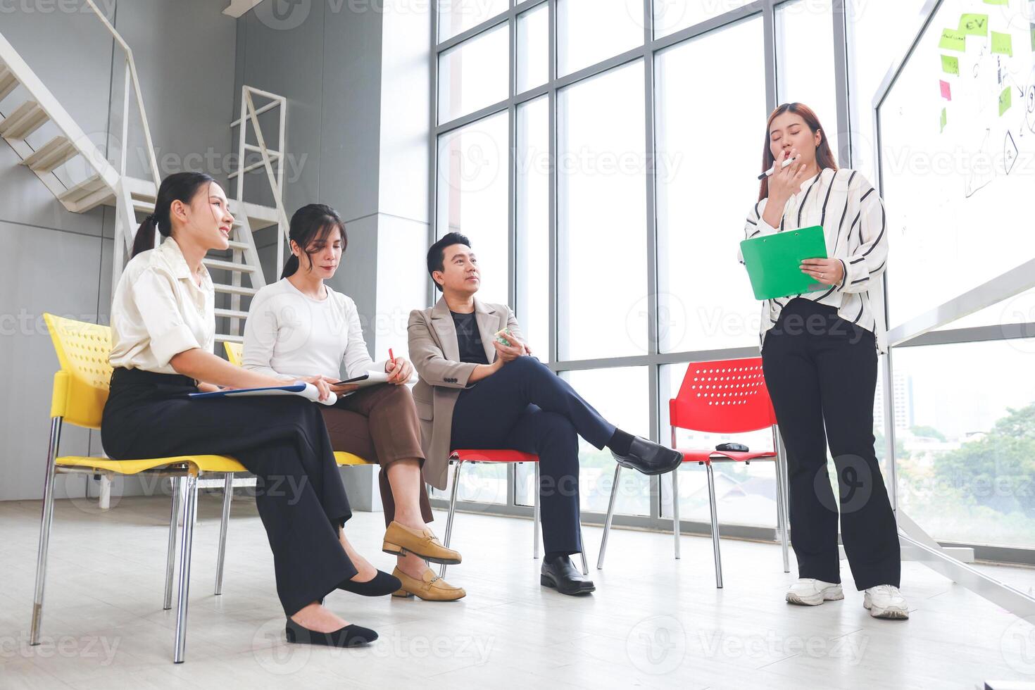 Businesswoman Leading Presentation in Modern Office, Business Team Meeting Presentation in Office, Professional Asian Colleagues Discussing Ideas in a Workspace photo