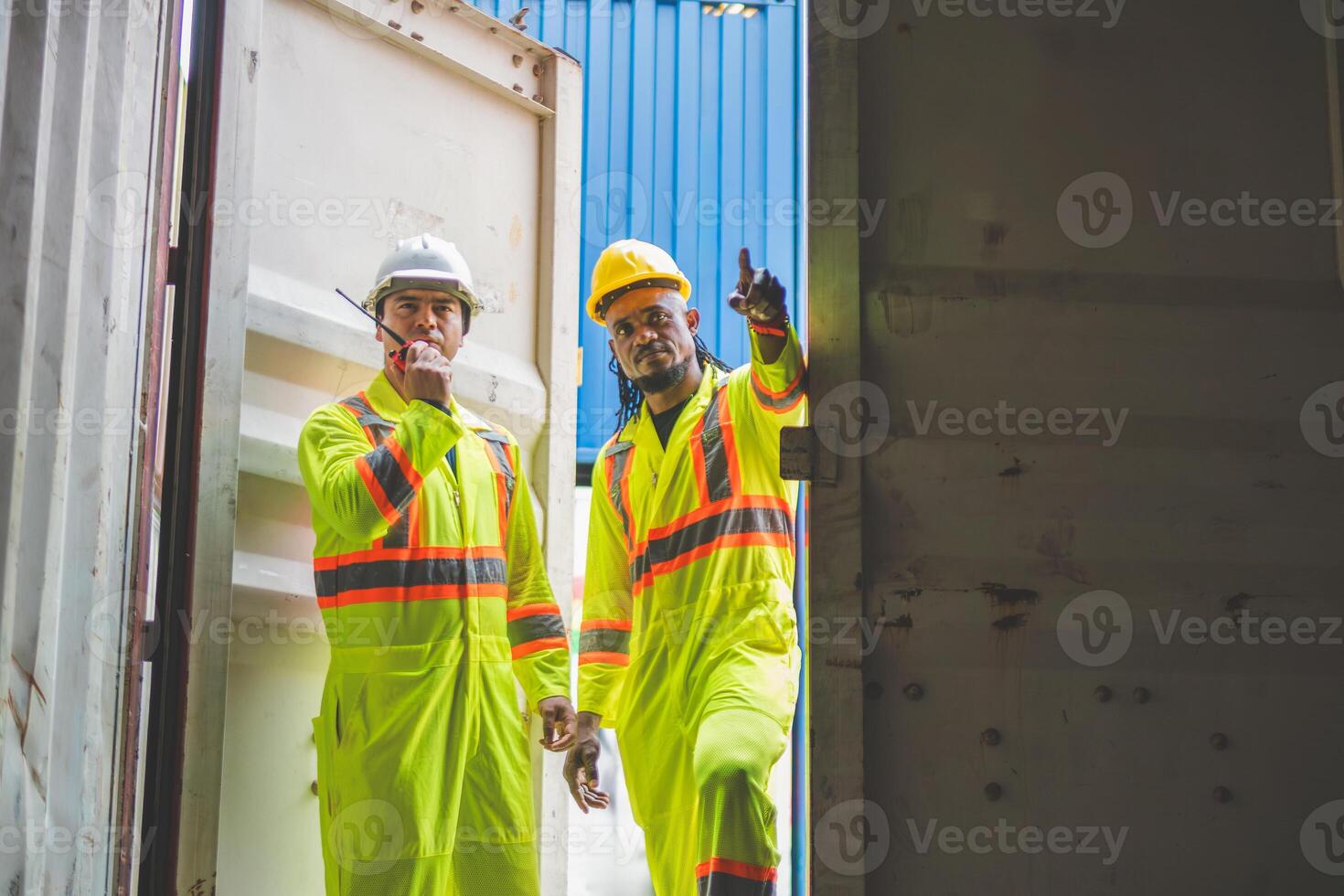 Logistics professional inspecting containers box, Engineers man checking containers box in in Industry containers yard photo