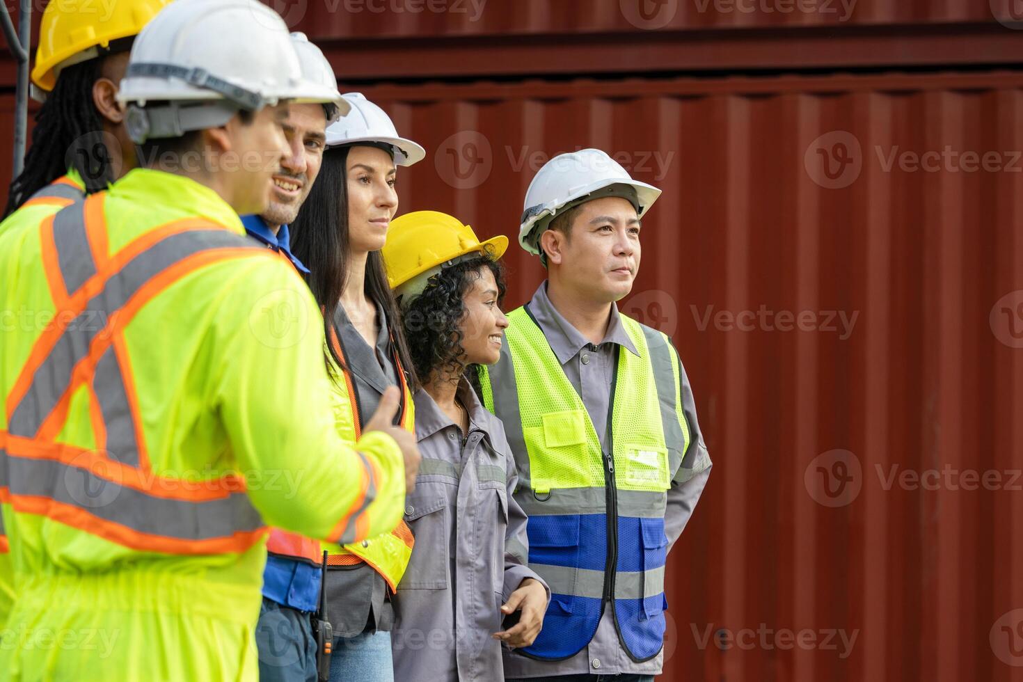 Diverse Team of Construction Workers and Engineers at a Job Site, Group of Multi Ethnic Industrial Professionals in Hard Hats and Safety Vests, Collaboration and Diversity in the Modern Workforce photo
