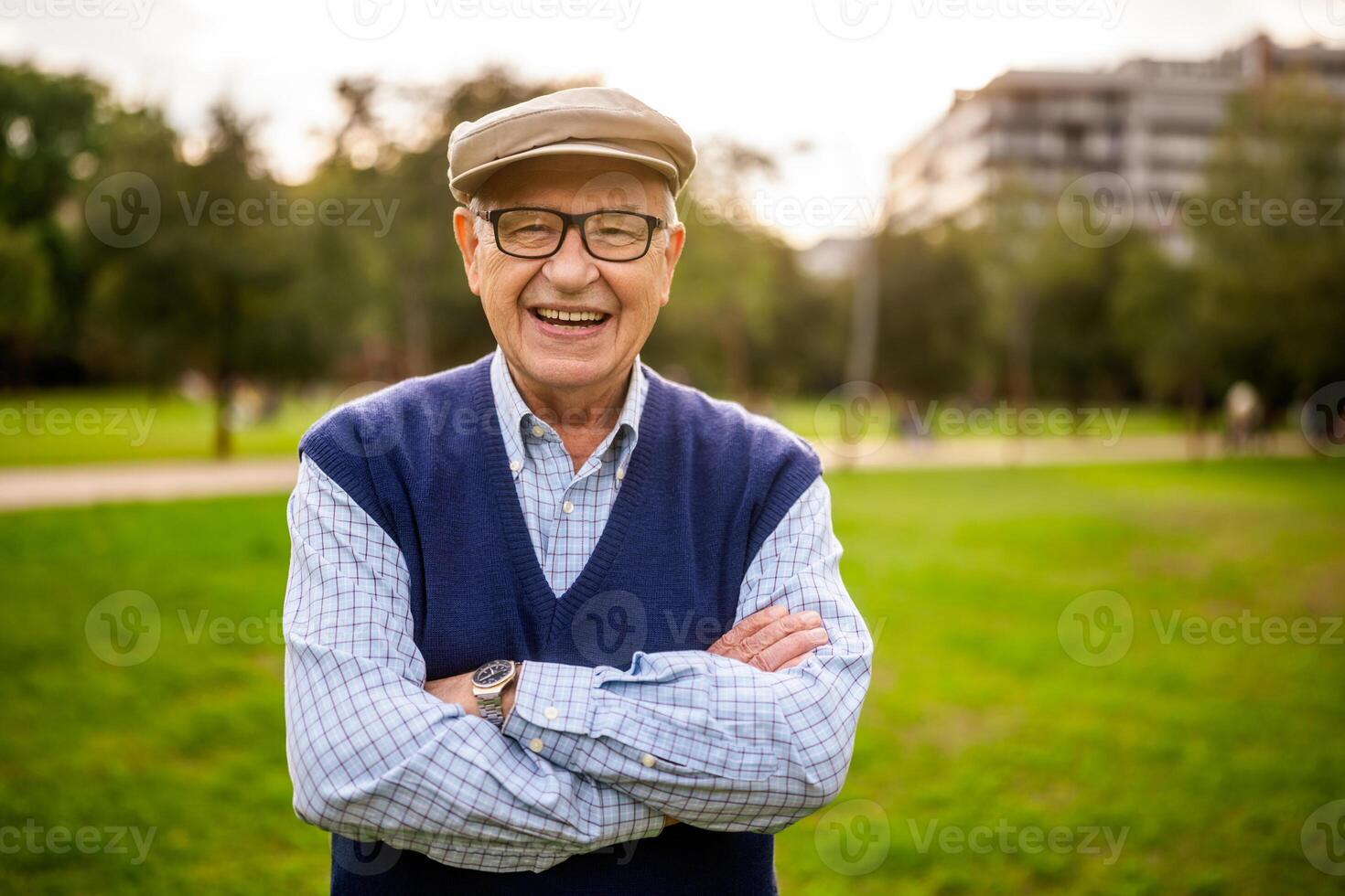 Senior male smiling broadly in a natural park environment, demonstrating joy and active lifestyle in retirement. photo