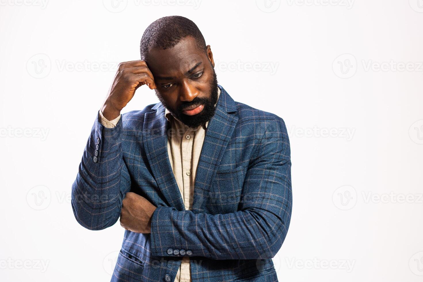 Pensive black male manager with a beard, expressing anxiety and frustration while deep in thought. photo