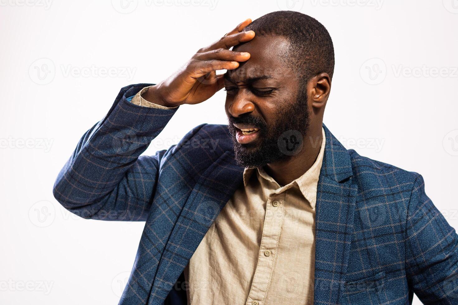 Portrait of African American businessman with hand on head, expressing physical and emotional strain. Copy space for your text or advertisement. photo