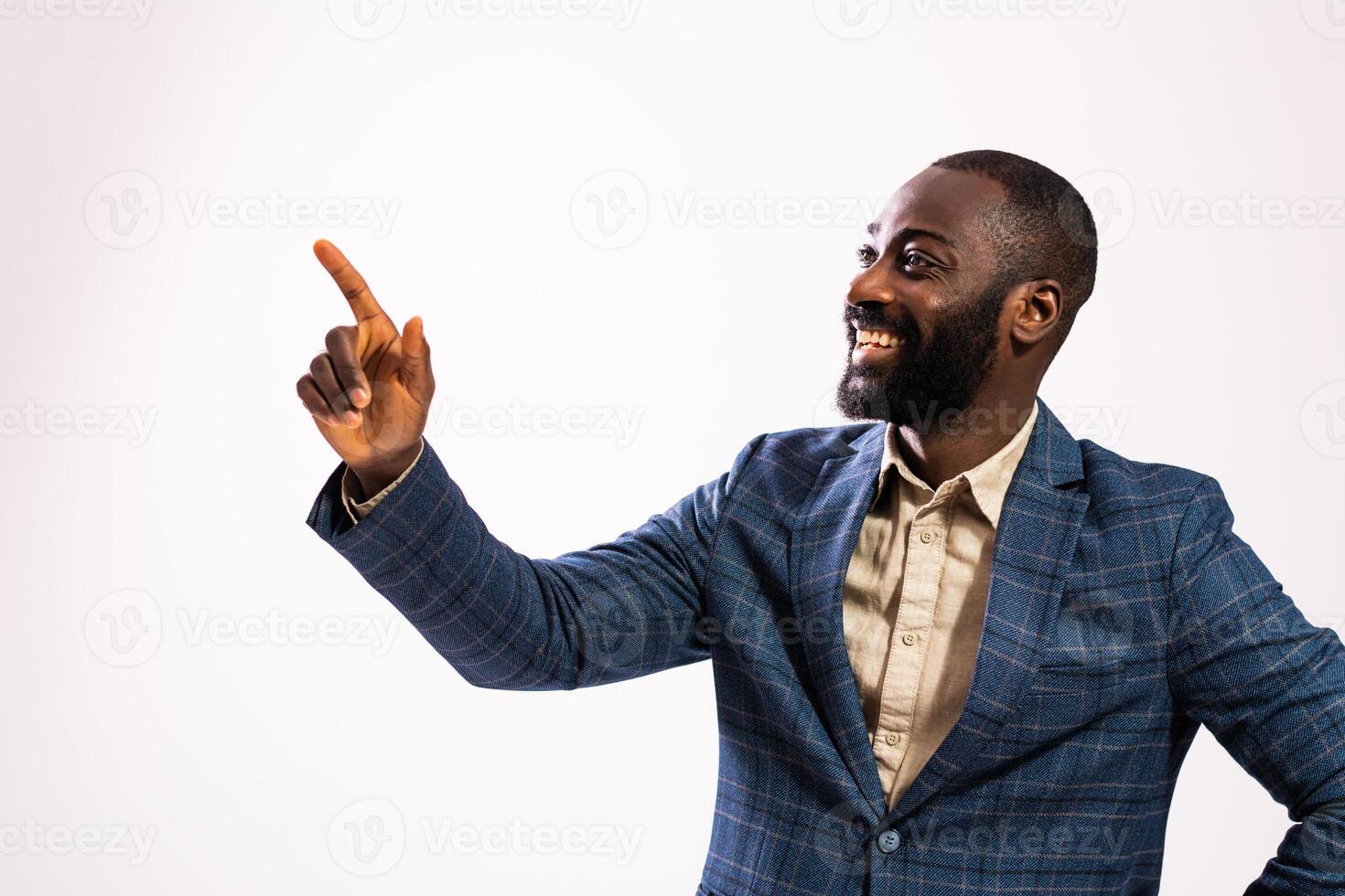 Handsome black businessperson with confident expression, pointing to empty gray background for your branding. photo
