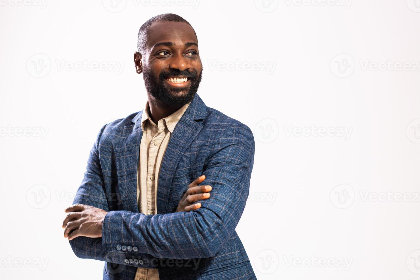 Studio shot of confident African American businessman with arms crossed smiling with pride and satisfaction. photo