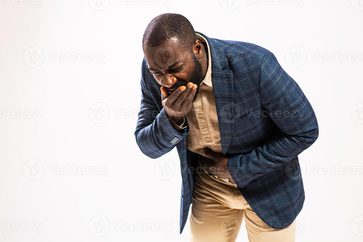 Exhausted black businessman in suit suffering from nausea and emotional distress. He is vomiting. photo