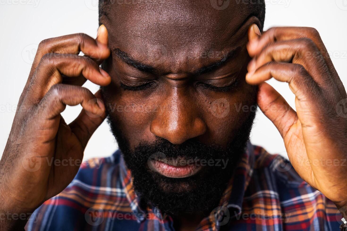 Close up portrait of stressed African American man having a headache, captured in a moment of emotional vulnerability. photo