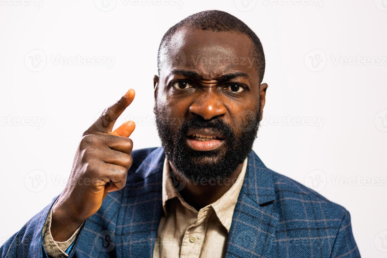 Studio shot of black male boss with a tense and displeased expression, symbolizing frustration and threats. photo
