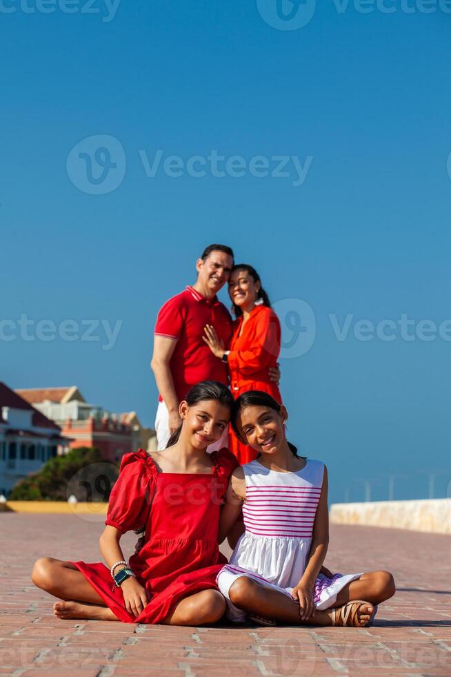 Family of four traveling together. Family love concept. Travel concept. Cartagena de Indias, Colombia. photo