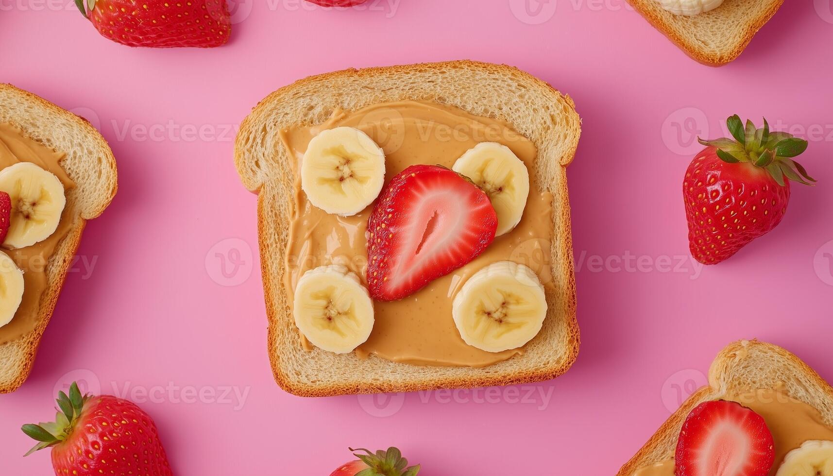 Slice bread with peanut jam topping, banana and strawberry pink background photo