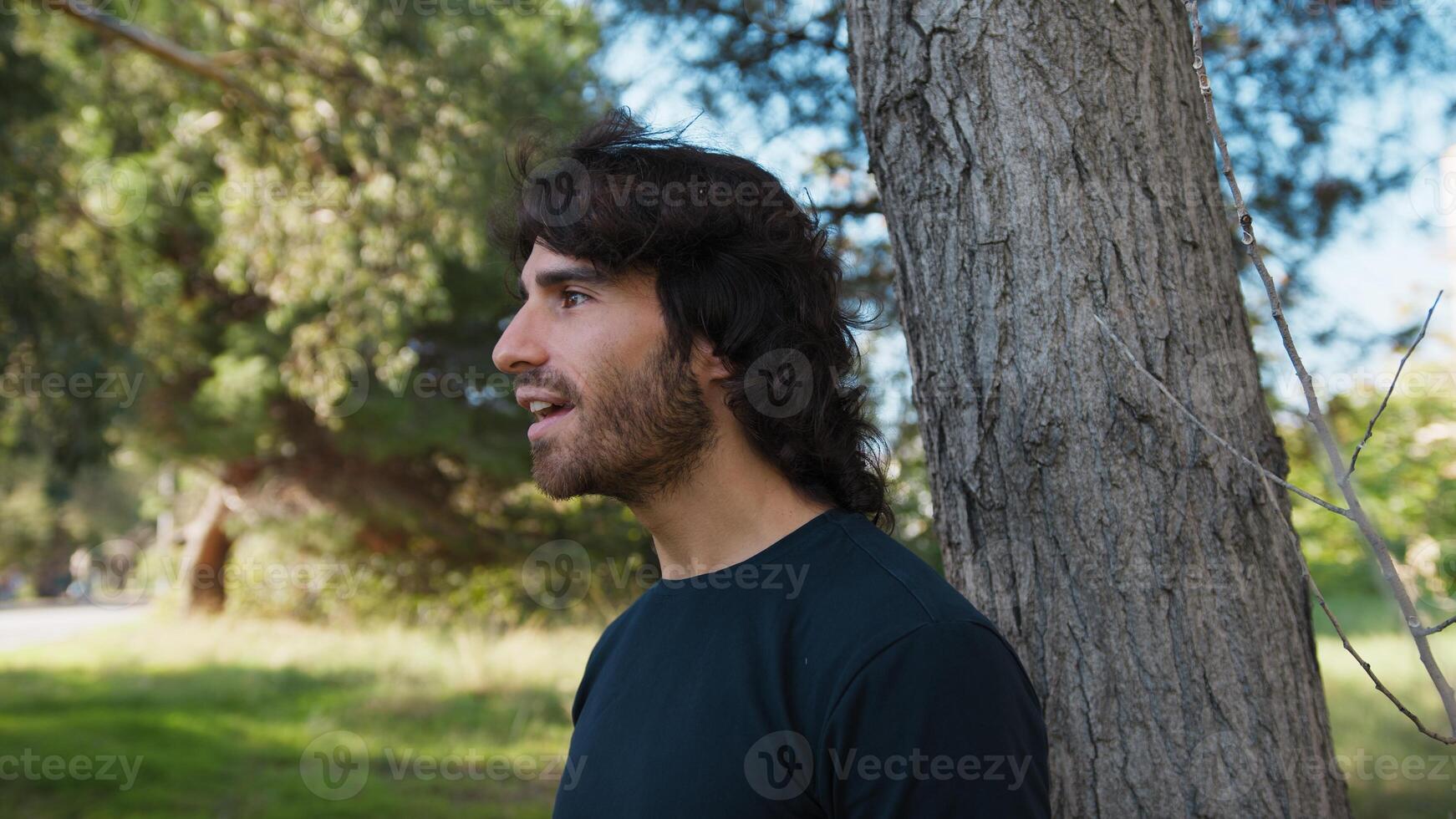 Young Long Hair Man Smiles Happy Amazed At Having Seen A Little Bird Outdoor photo