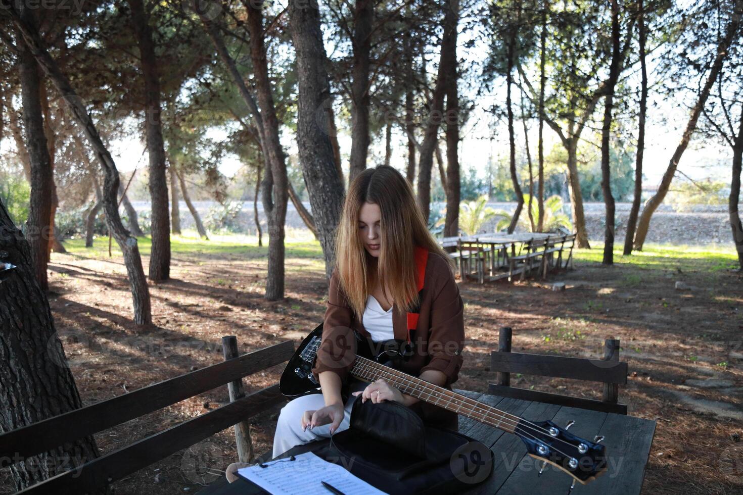 Girl Music On Table With Bass Instrument In Nature Outdoor photo