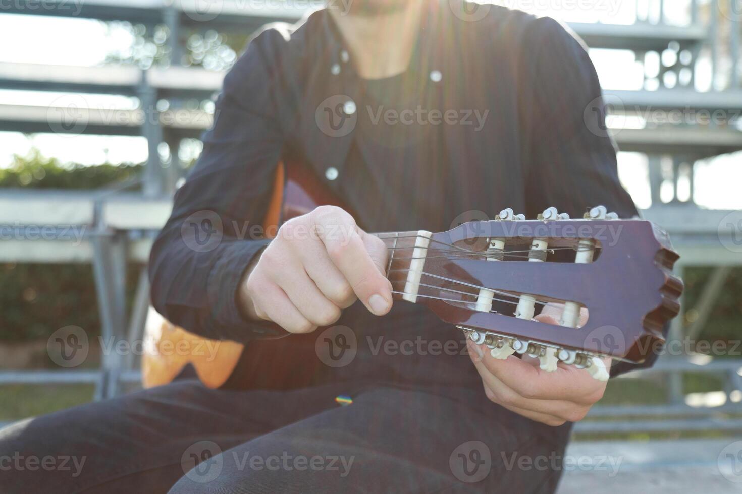 Hand Turns Wrench For Manual Tuning Of Guitar Outdoor photo