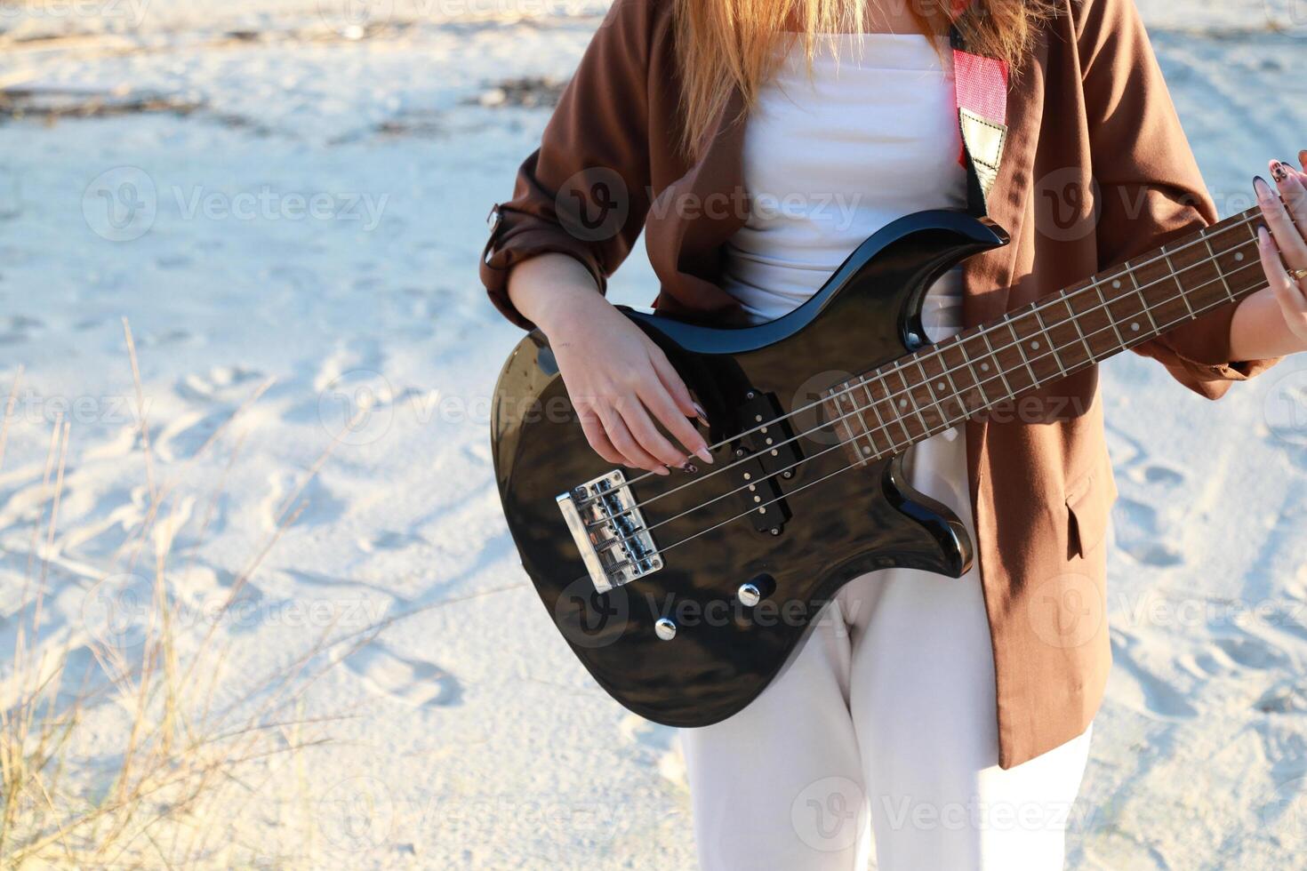 Girl Bass Music Instrument On The Beach At Sunset Near Ocean Outside photo
