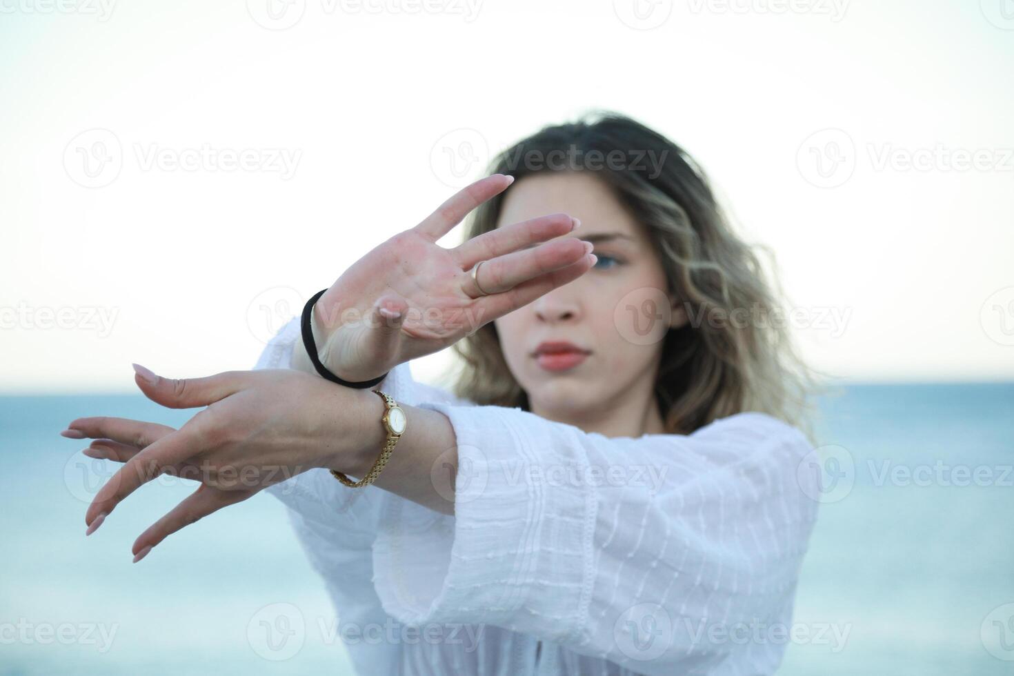hands of a Woman White Dresses Dances Near Calm Ocean In Sicily Island photo